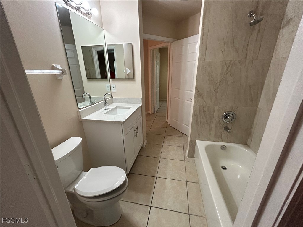 3719 32nd Street Southwest Lehigh Acres, FL 33976 - Photo 14 of 15 a bathroom with a toilet sink and mirror