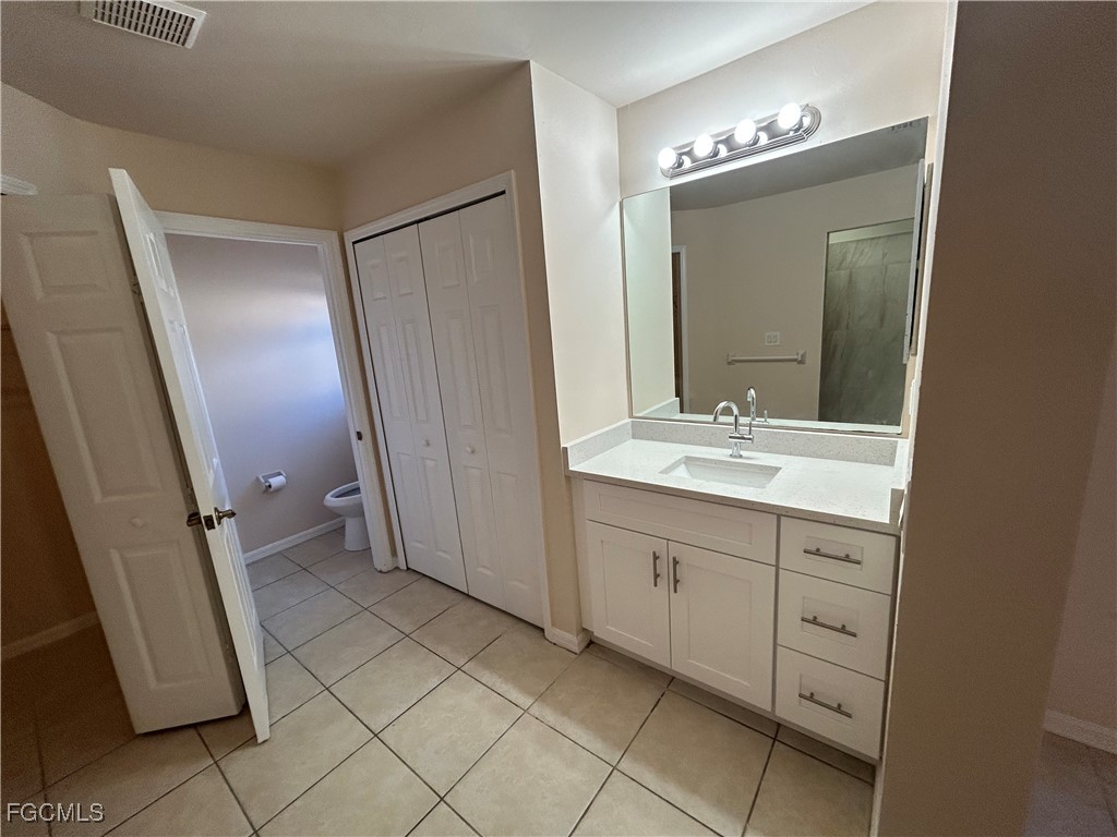 3719 32nd Street Southwest Lehigh Acres, FL 33976 - Photo 10 of 15 a bathroom with a double vanity sink and mirror