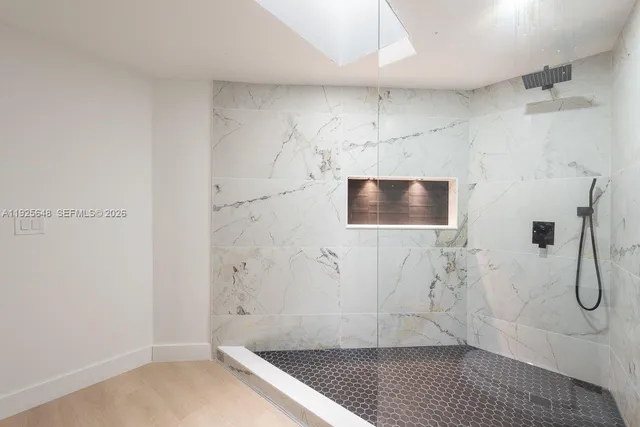 a bathroom with a double vanity sink toilet and a mirror