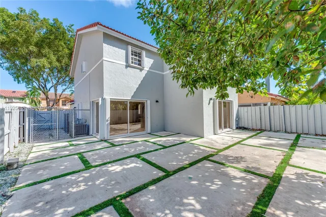 a white house with trees in front of it
