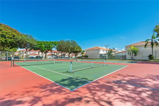 a front view of a house with a garden and yard