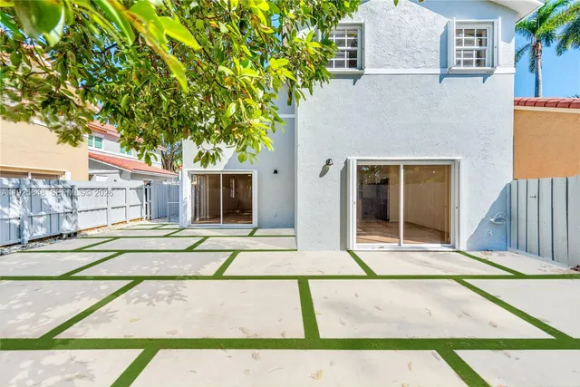 an aerial view of multiple houses with yard