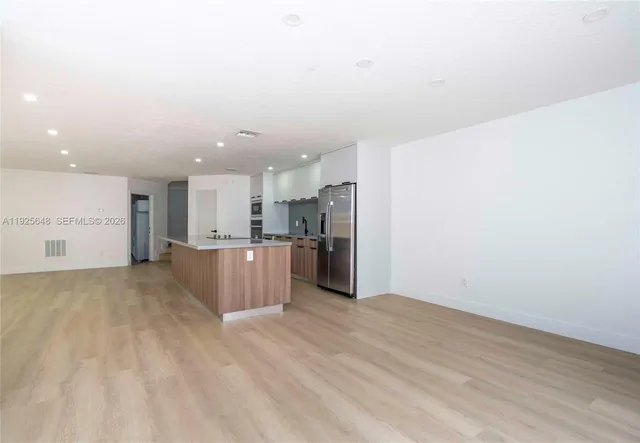 a view of kitchen appliances and cabinets