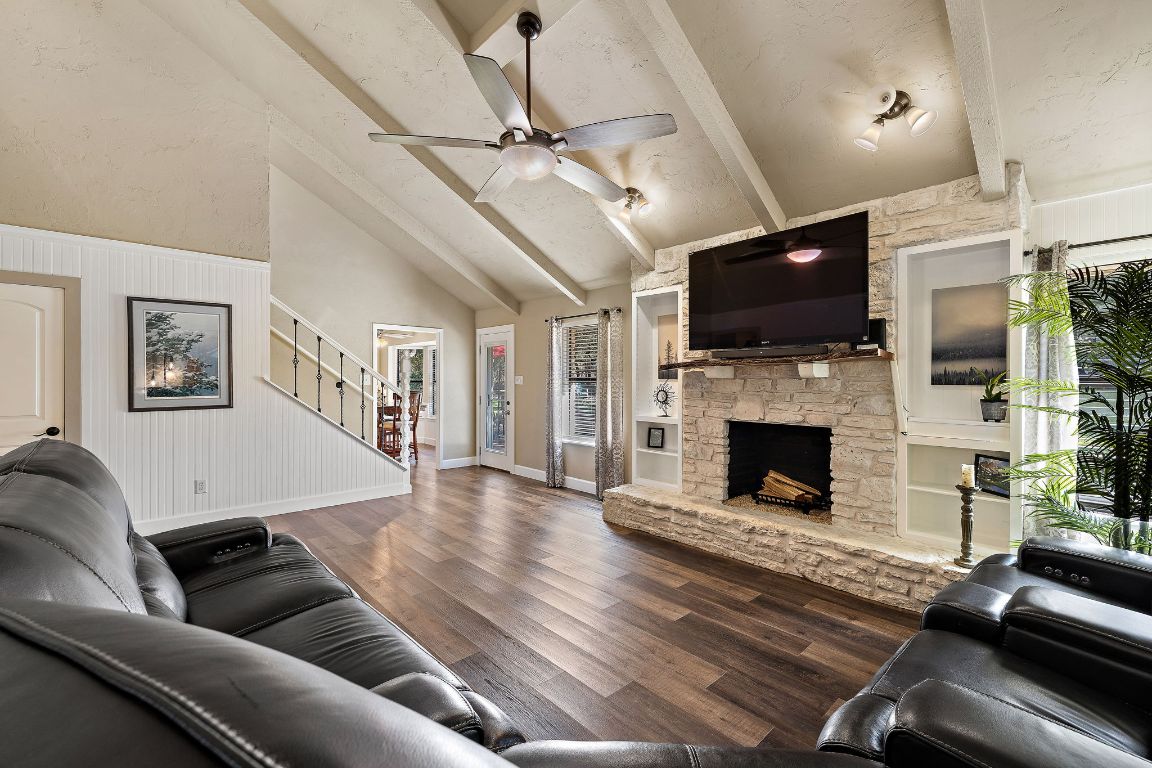 4203 Azul Court Georgetown, TX 78628 - Photo 19 of 38 a living room with furniture a flat screen tv and a fireplace