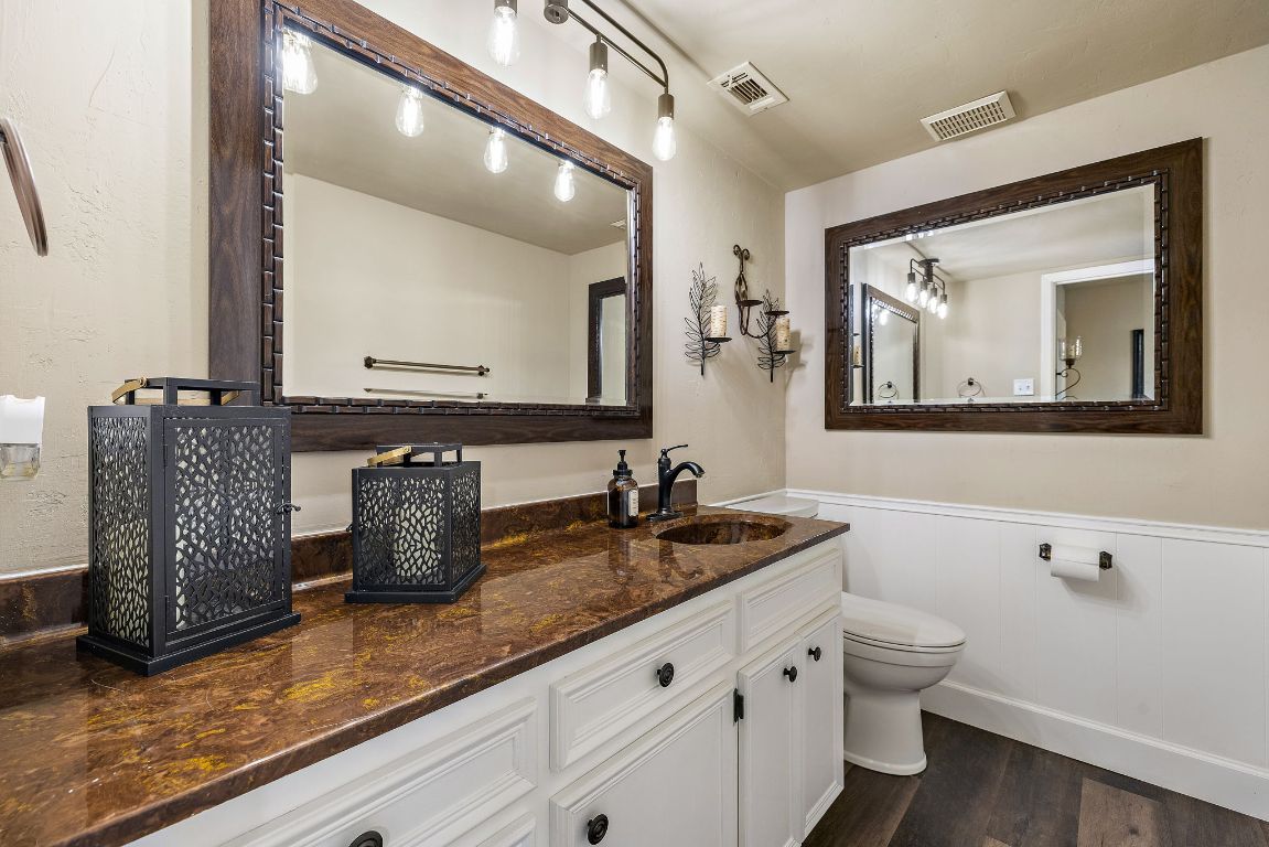 4203 Azul Court Georgetown, TX 78628 - Photo 23 of 38 a bathroom with a toilet a sink and mirror