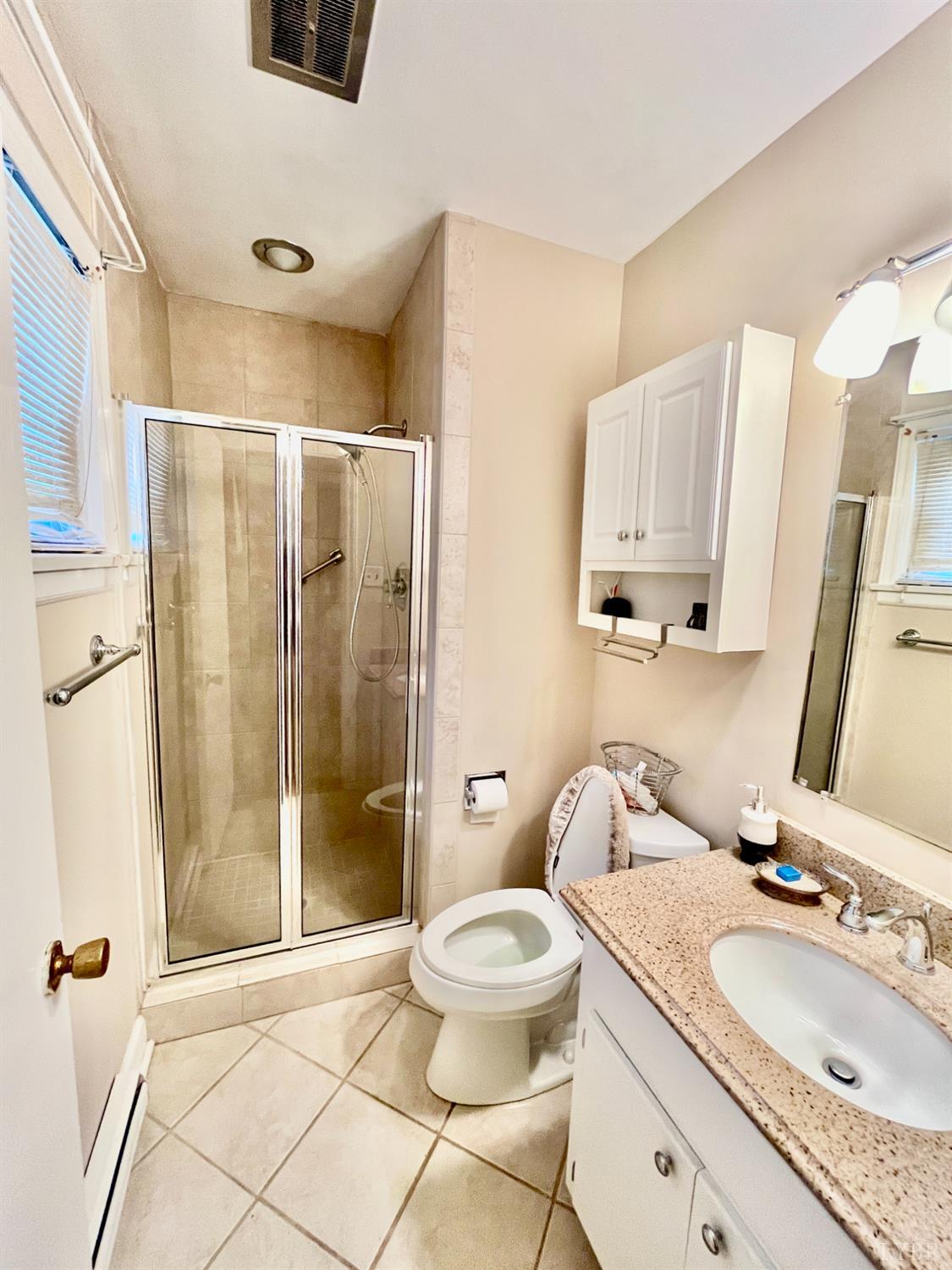 4316 Montgomery Road Lynchburg, VA 24503 - Photo 14 of 19 a bathroom with a granite countertop sink toilet and shower