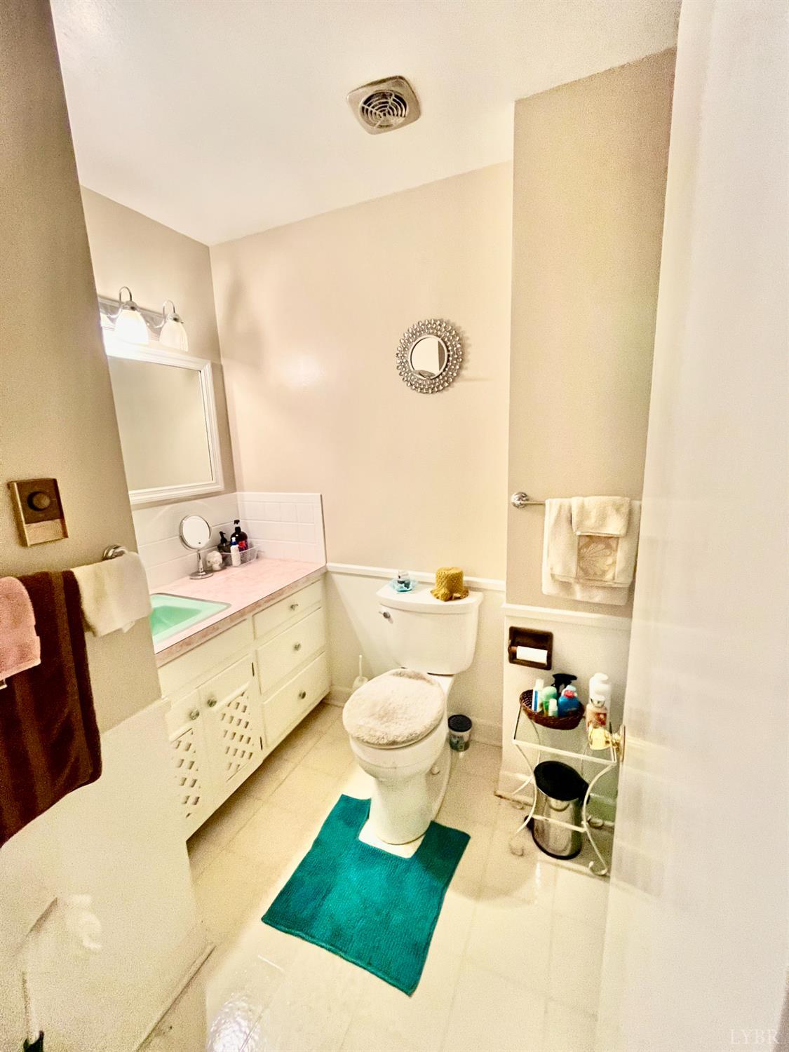 4316 Montgomery Road Lynchburg, VA 24503 - Photo 10 of 19 a bathroom with a sink mirror vanity and toilet