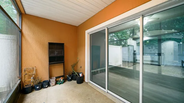 a view of a room with floor to ceiling window and an outdoor shower