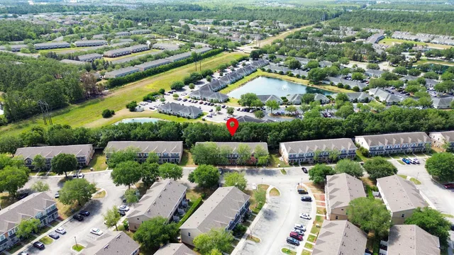 an outdoor space with lots of white chairs and a couch