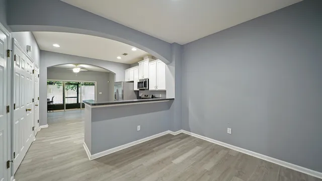a view of a kitchen with a sink and cabinets
