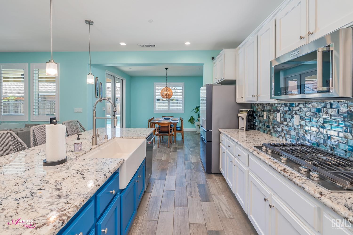 Undisclosed Address Bakersfield, CA 93314 - Photo 18 of 40 a kitchen with granite countertop a sink stove and cabinets
