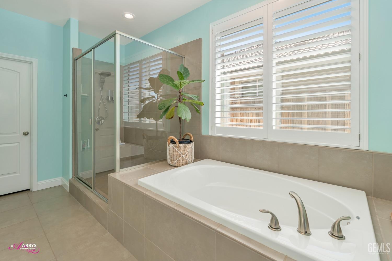 Undisclosed Address Bakersfield, CA 93314 - Photo 24 of 40 a bathroom with a tub and a shower