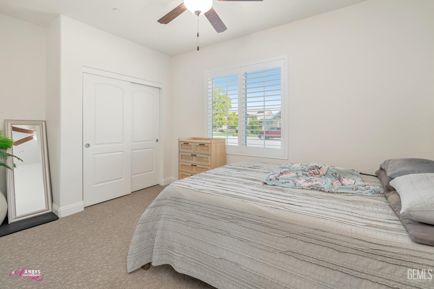 Undisclosed Address Bakersfield, CA 93314 - Photo 25 of 40 a bedroom with a bed and a chandelier