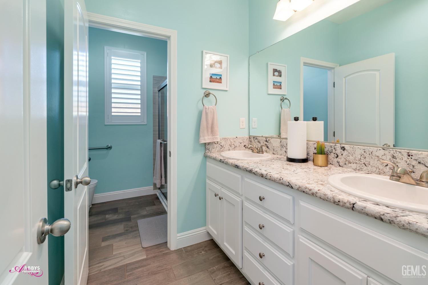 Undisclosed Address Bakersfield, CA 93314 - Photo 27 of 40 a bathroom with a granite countertop sink and a mirror