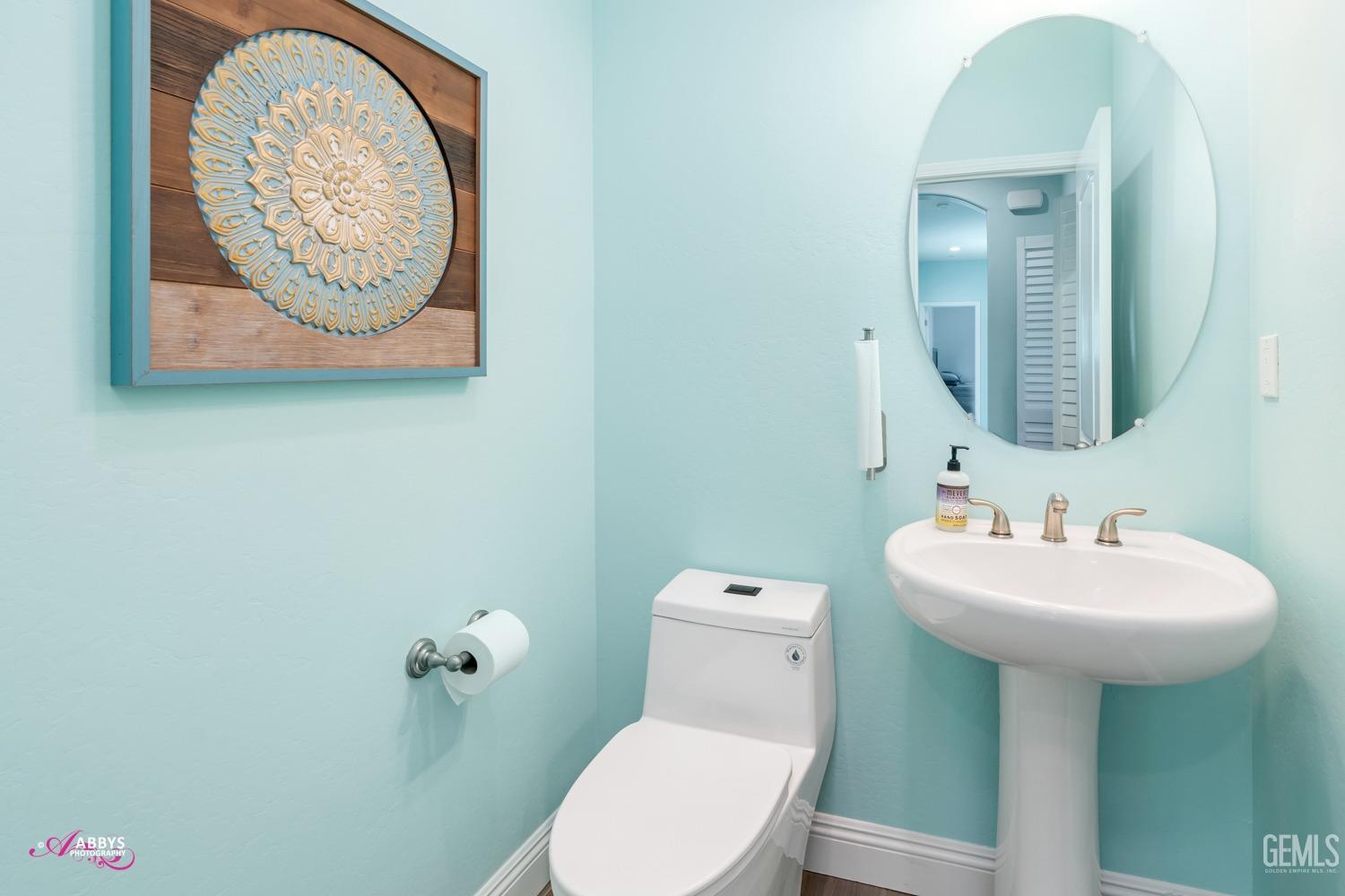 Undisclosed Address Bakersfield, CA 93314 - Photo 29 of 40 a bathroom with a toilet a sink and mirror