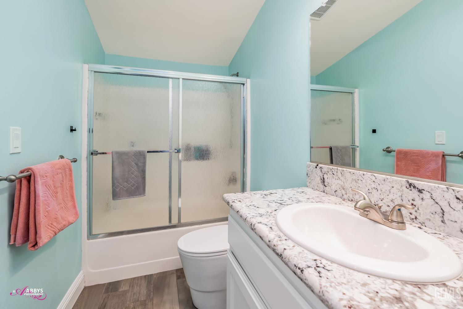 Undisclosed Address Bakersfield, CA 93314 - Photo 34 of 40 a bath room with a toilet sink and shower