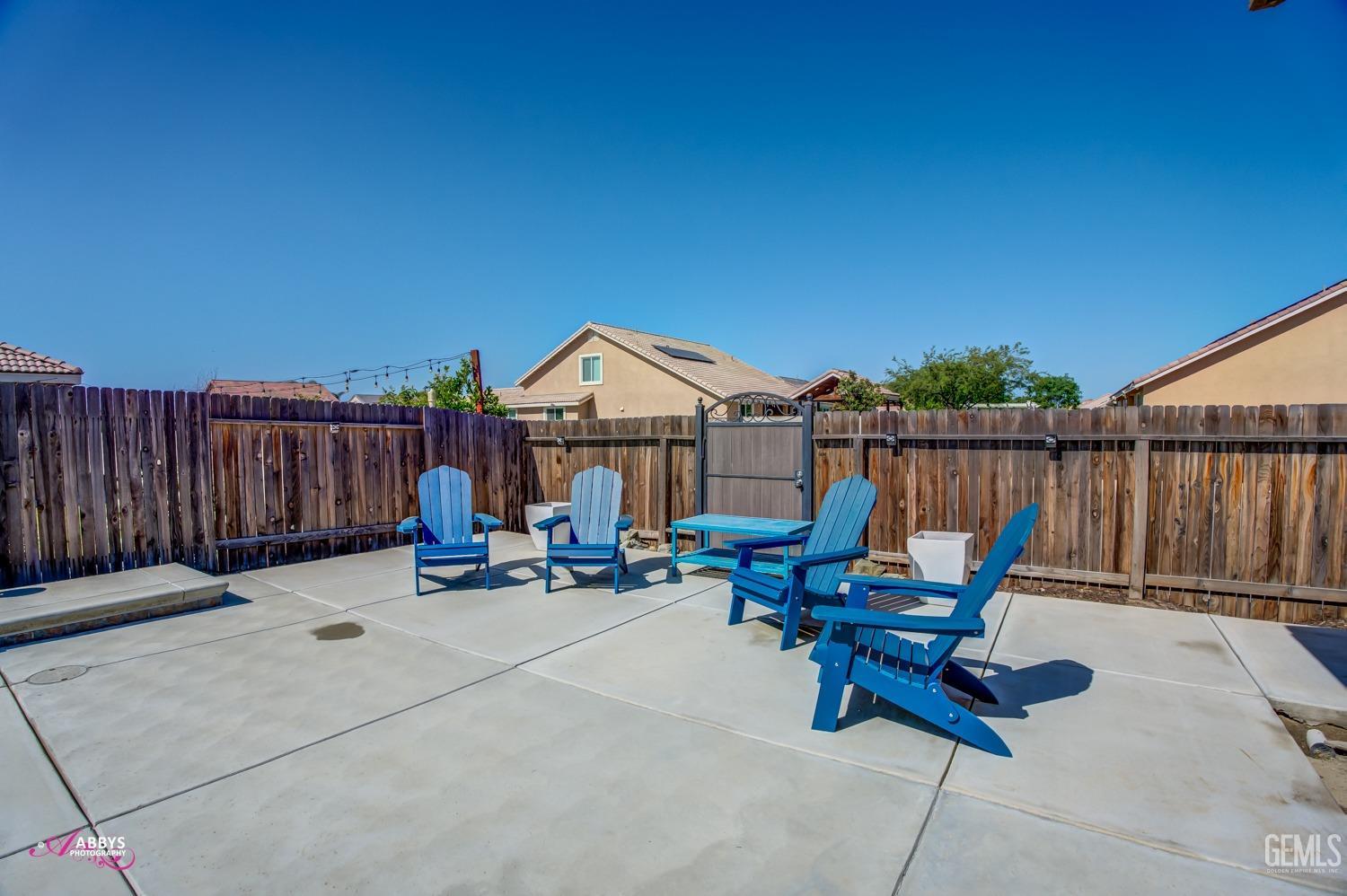 Undisclosed Address Bakersfield, CA 93314 - Photo 40 of 40 a view of a patio with table and chairs with wooden fence