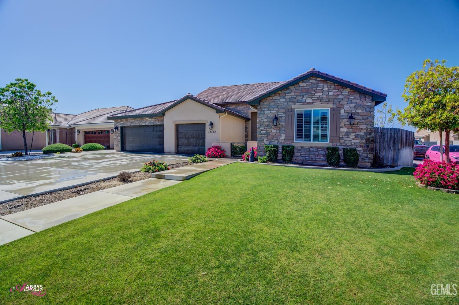 Undisclosed Address Bakersfield, CA 93314 - Photo 7 of 40 a front view of house with yard and green space