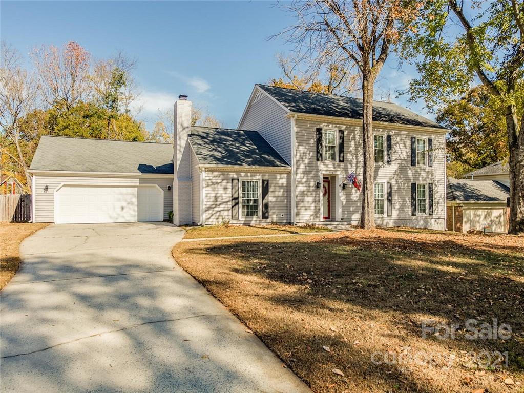 a front view of a house with a yard garage and outdoor seating