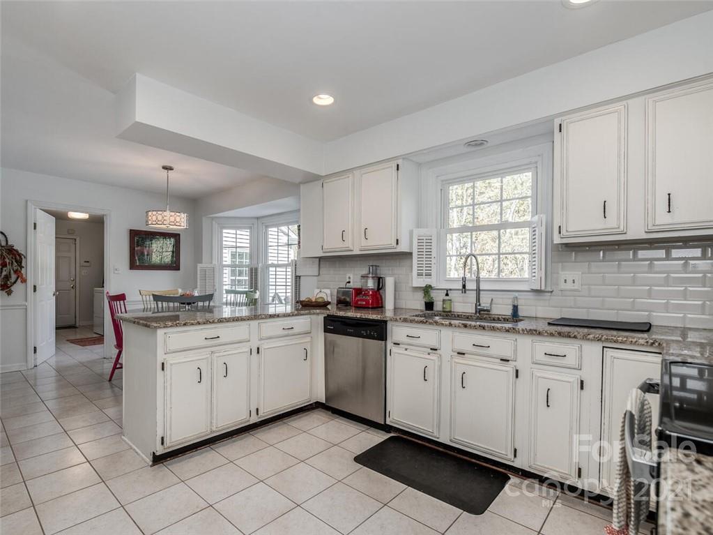 4312 Truscott Road Charlotte, NC 28226 - Photo 12 of 31 a kitchen with granite countertop white cabinets and white appliances