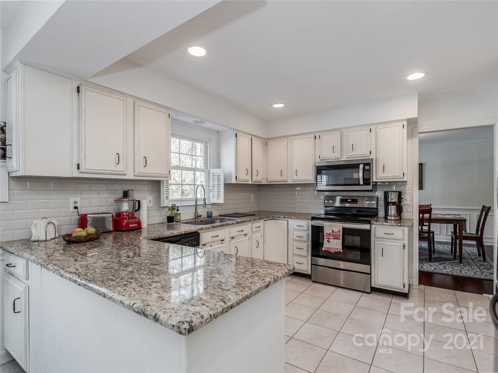 4312 Truscott Road Charlotte, NC 28226 - Photo 13 of 31 a kitchen with stainless steel appliances granite countertop a sink stove and cabinets