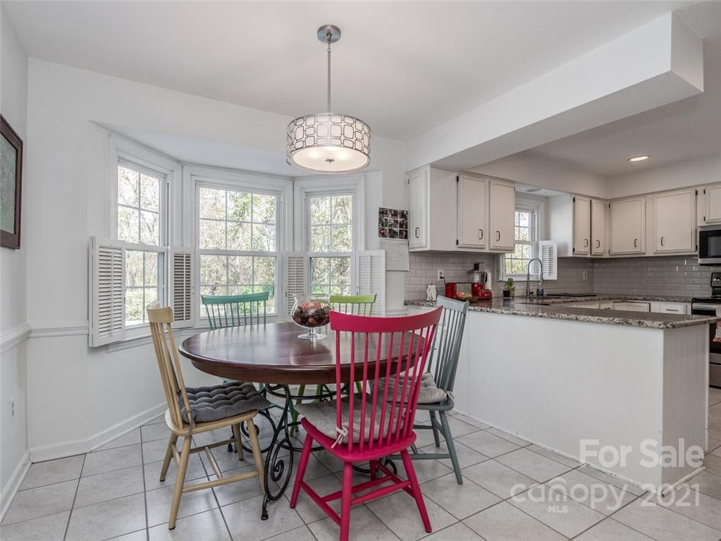4312 Truscott Road Charlotte, NC 28226 - Photo 14 of 31 a view of a dining room with furniture a chandelier and wooden floor