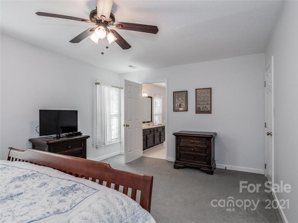 4312 Truscott Road Charlotte, NC 28226 - Photo 18 of 31 a bedroom with a bed and a television