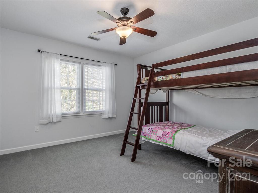 4312 Truscott Road Charlotte, NC 28226 - Photo 22 of 31 a bedroom with a bed and a chandelier