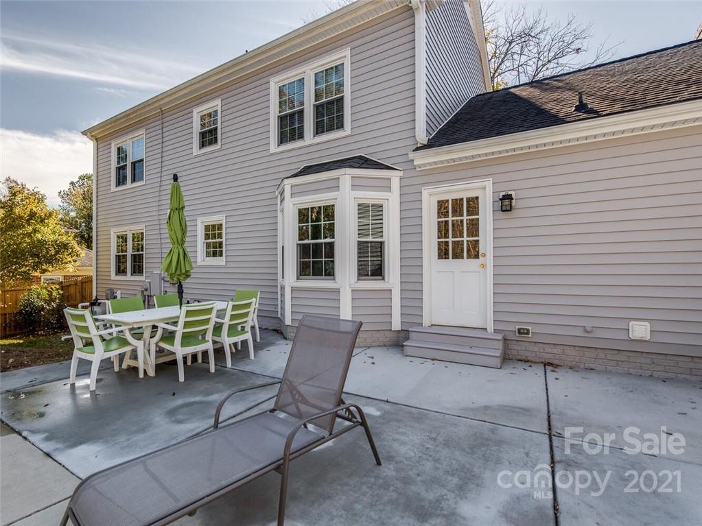 4312 Truscott Road Charlotte, NC 28226 - Photo 30 of 31 a patio with table and chairs and potted plants