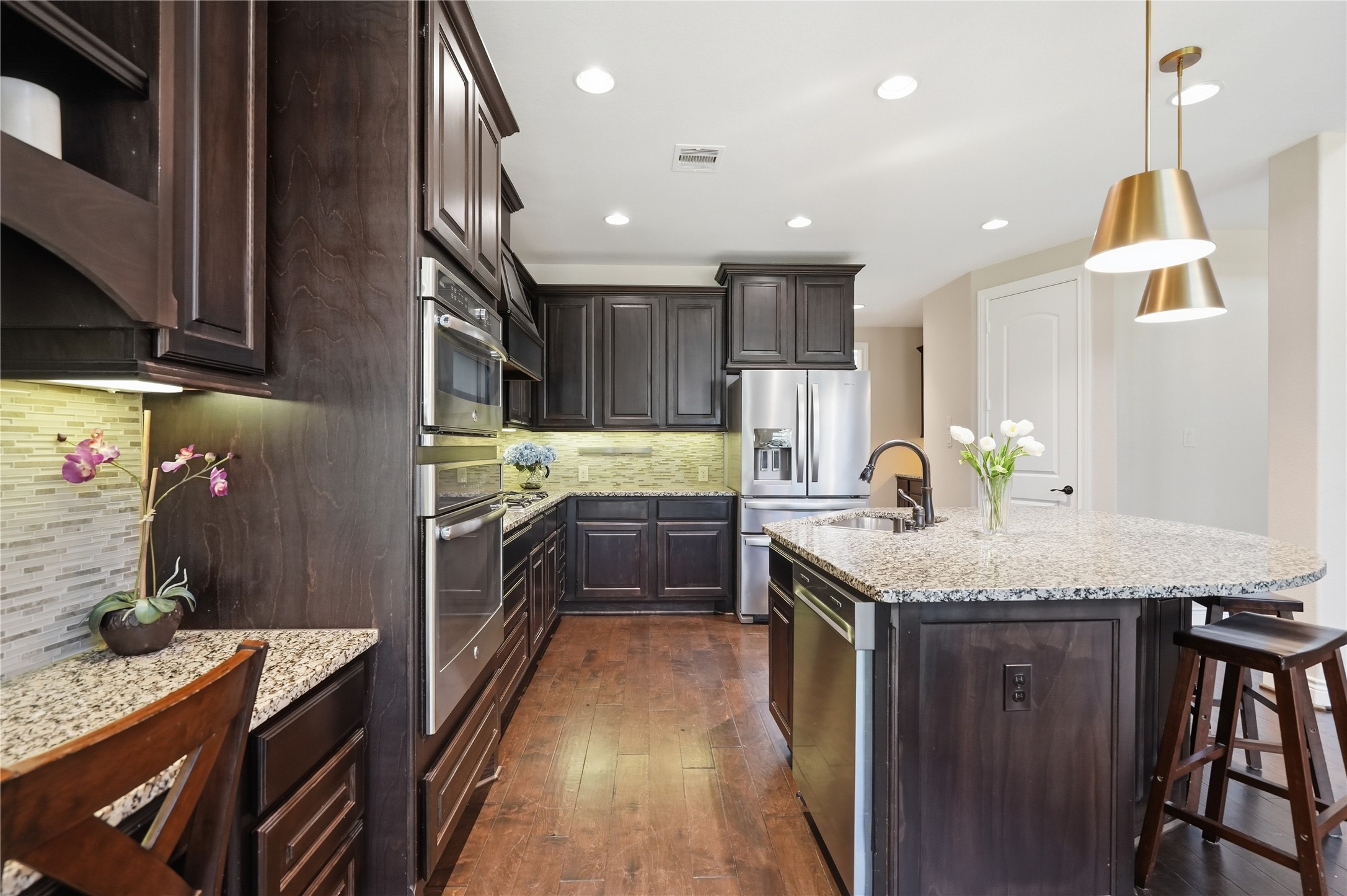 6429 Remlap Street Houston, TX 77055 - Photo 5 of 30 Light-filled kitchen with a statement island, gas range, and a built-in desk area perfect for planning meals, managing schedules, or homework time.