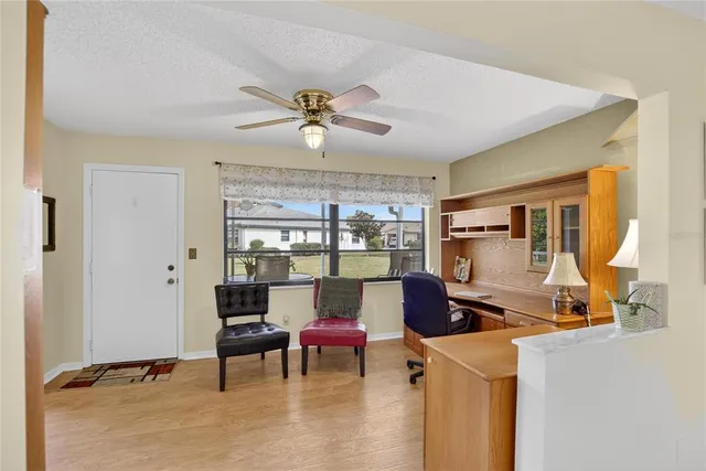 a spacious bedroom with a bed and a chandelier