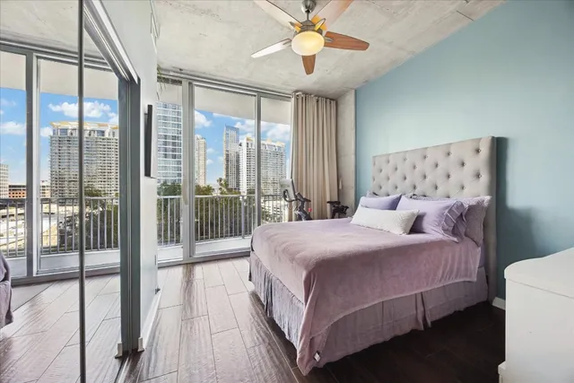a bedroom with a large bed and a chandelier