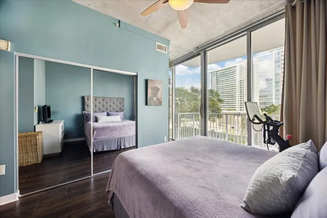 a bedroom with a bed and a large window