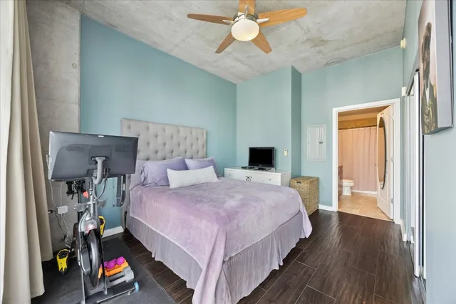 a bedroom with a bed and a chandelier