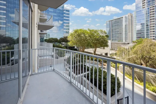 a view of a balcony with a floor to ceiling window and stairs
