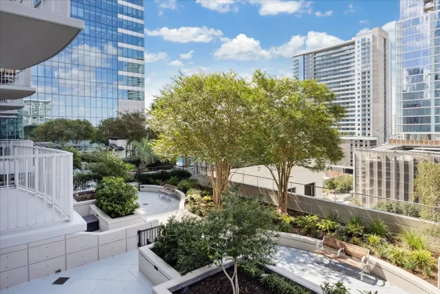a view of a house with a yard and potted plants