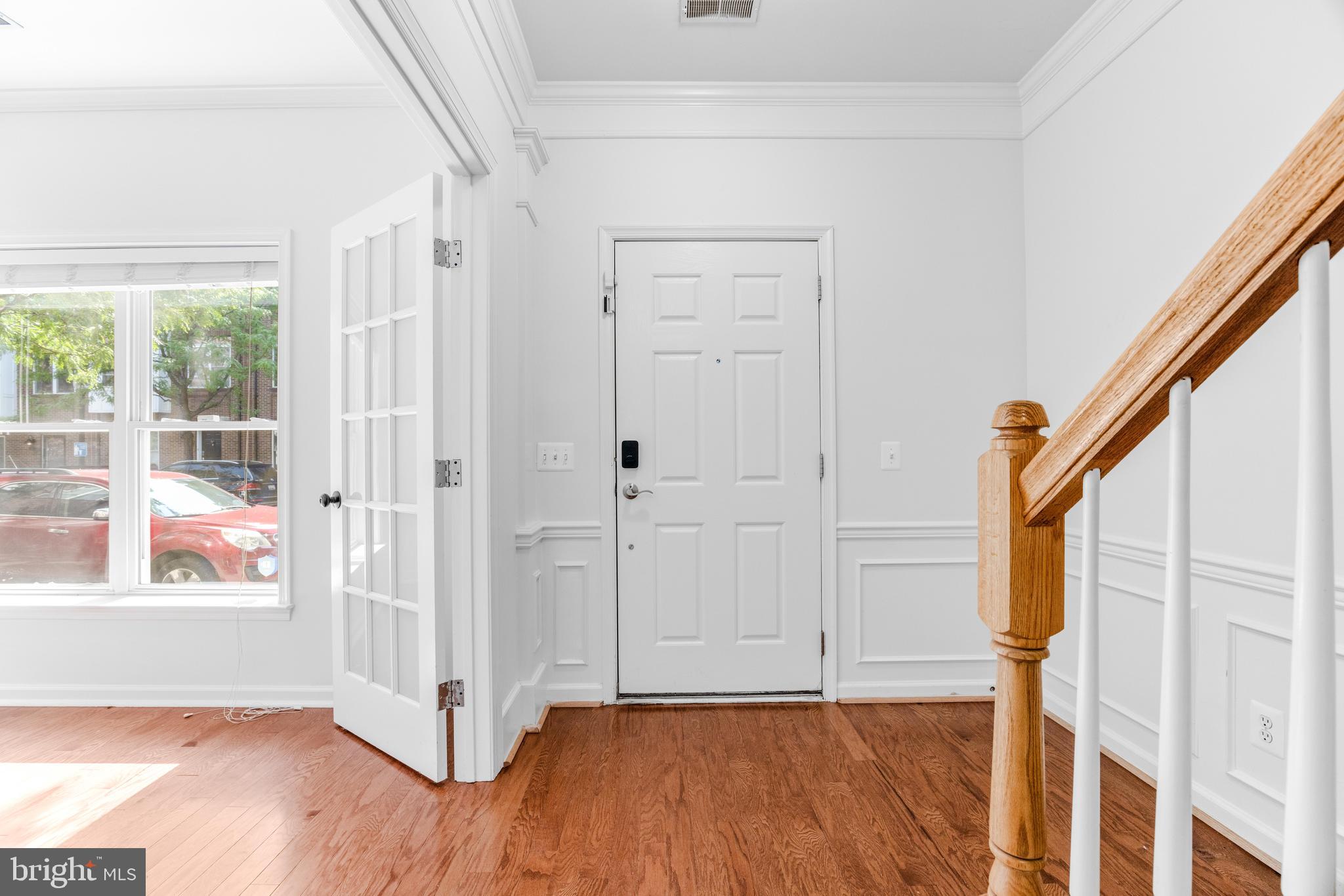 1436 Steuart Street Baltimore, MD 21230 - Photo 11 of 56 an empty room with wooden floor and windows