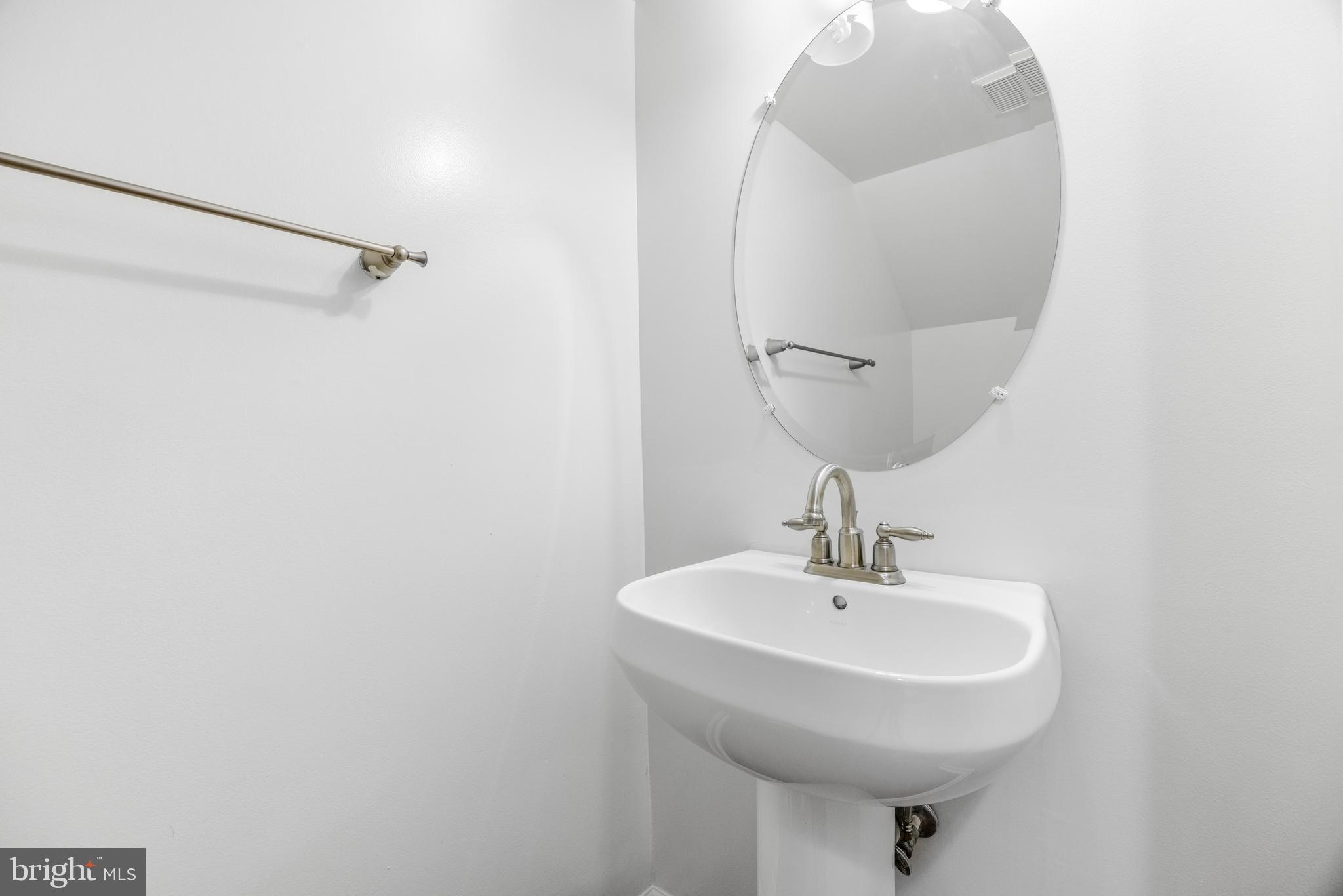 1436 Steuart Street Baltimore, MD 21230 - Photo 13 of 56 a bathroom with a sink and mirror