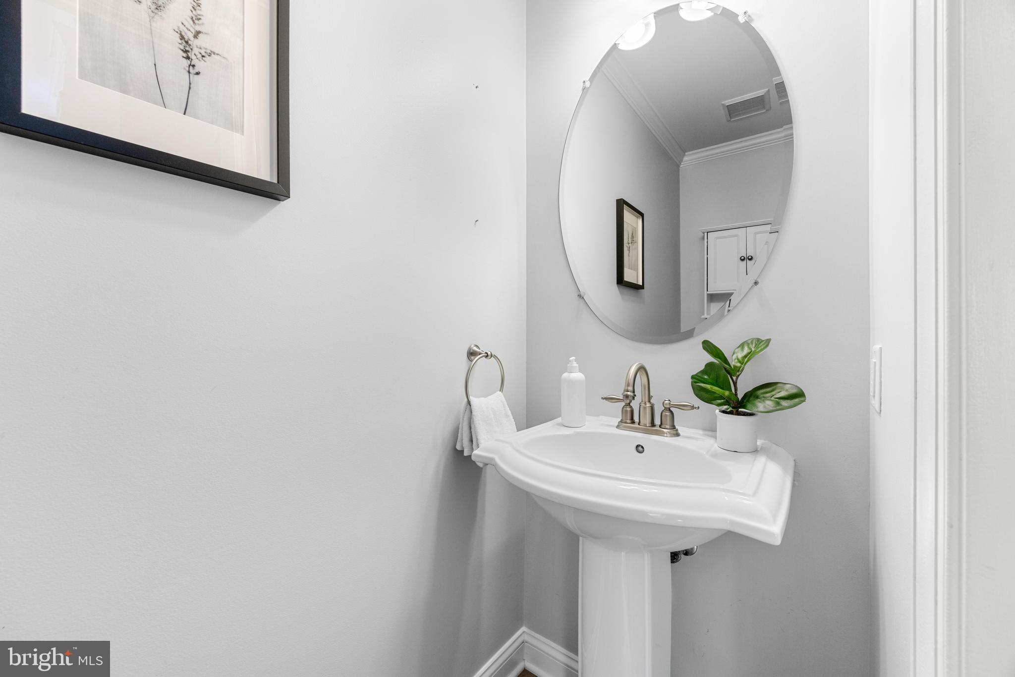 1436 Steuart Street Baltimore, MD 21230 - Photo 23 of 56 a bathroom with a sink and a mirror