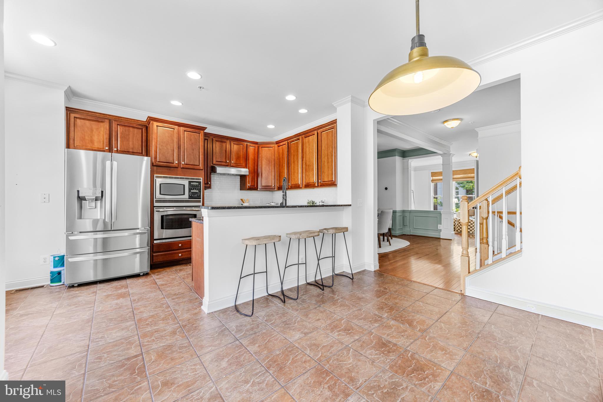 1436 Steuart Street Baltimore, MD 21230 - Photo 26 of 56 a kitchen with stainless steel appliances kitchen island granite countertop a refrigerator and a stove top oven