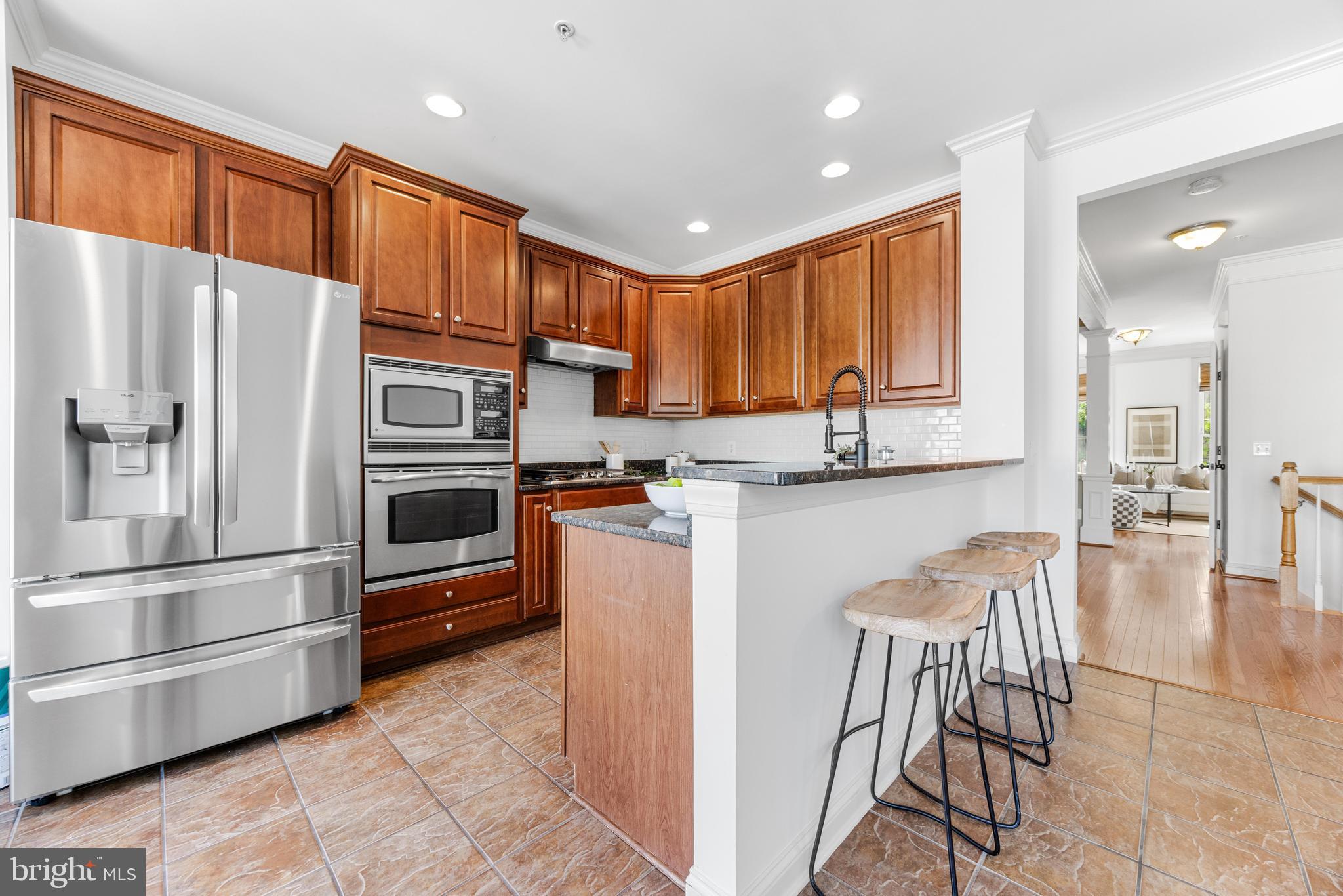 1436 Steuart Street Baltimore, MD 21230 - Photo 29 of 56 a kitchen with stainless steel appliances granite countertop a refrigerator and a stove top oven
