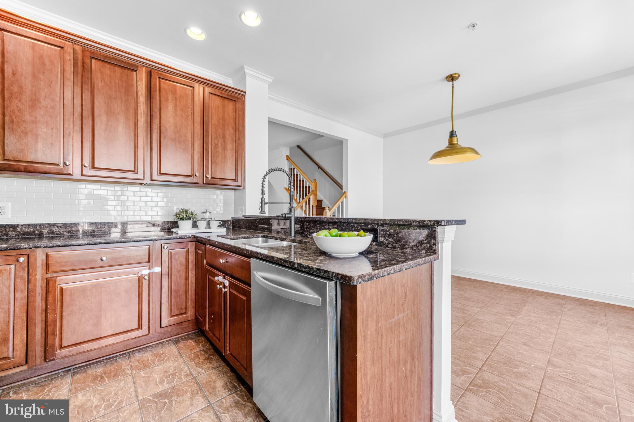 1436 Steuart Street Baltimore, MD 21230 - Photo 30 of 56 a kitchen with stainless steel appliances granite countertop a sink and a stove