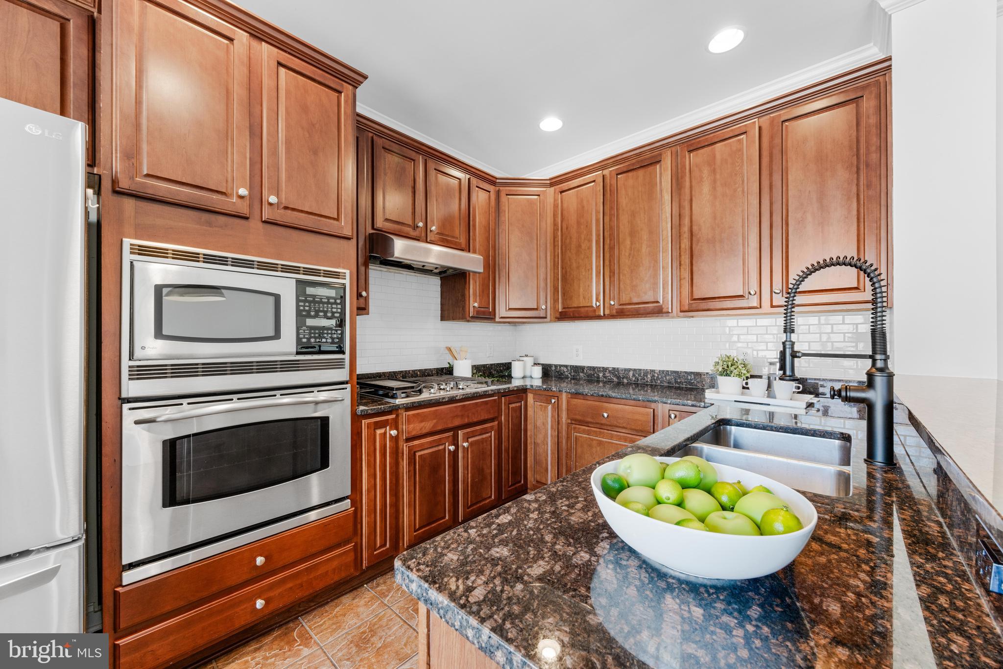 1436 Steuart Street Baltimore, MD 21230 - Photo 31 of 56 a kitchen with a stove a sink and a microwave