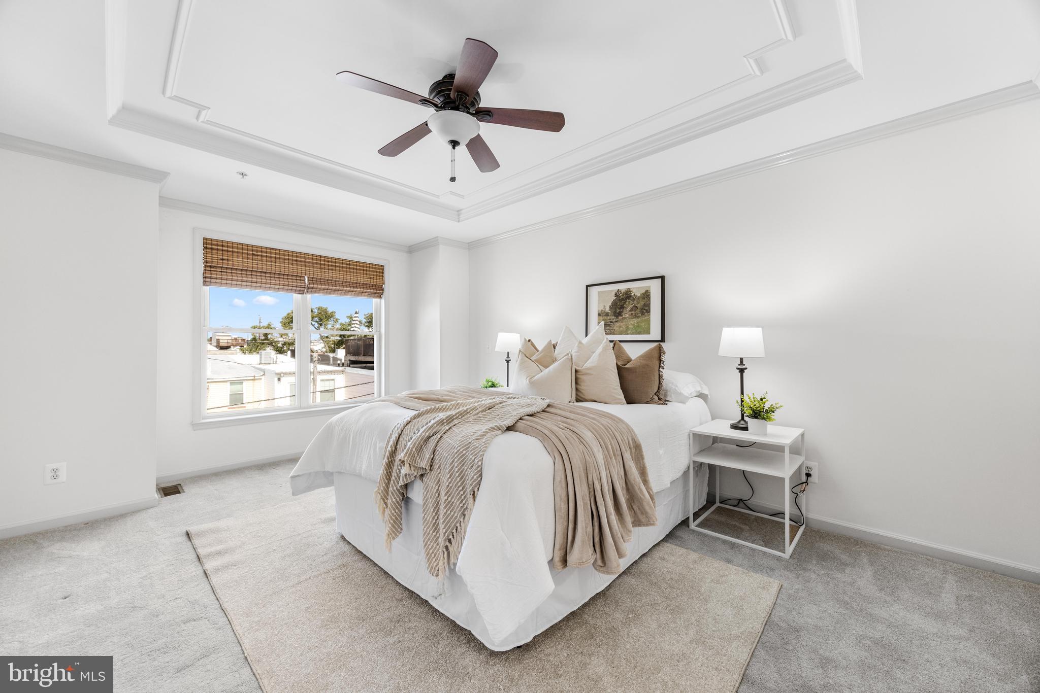 1436 Steuart Street Baltimore, MD 21230 - Photo 36 of 56 a spacious bedroom with a bed a window and a chandelier