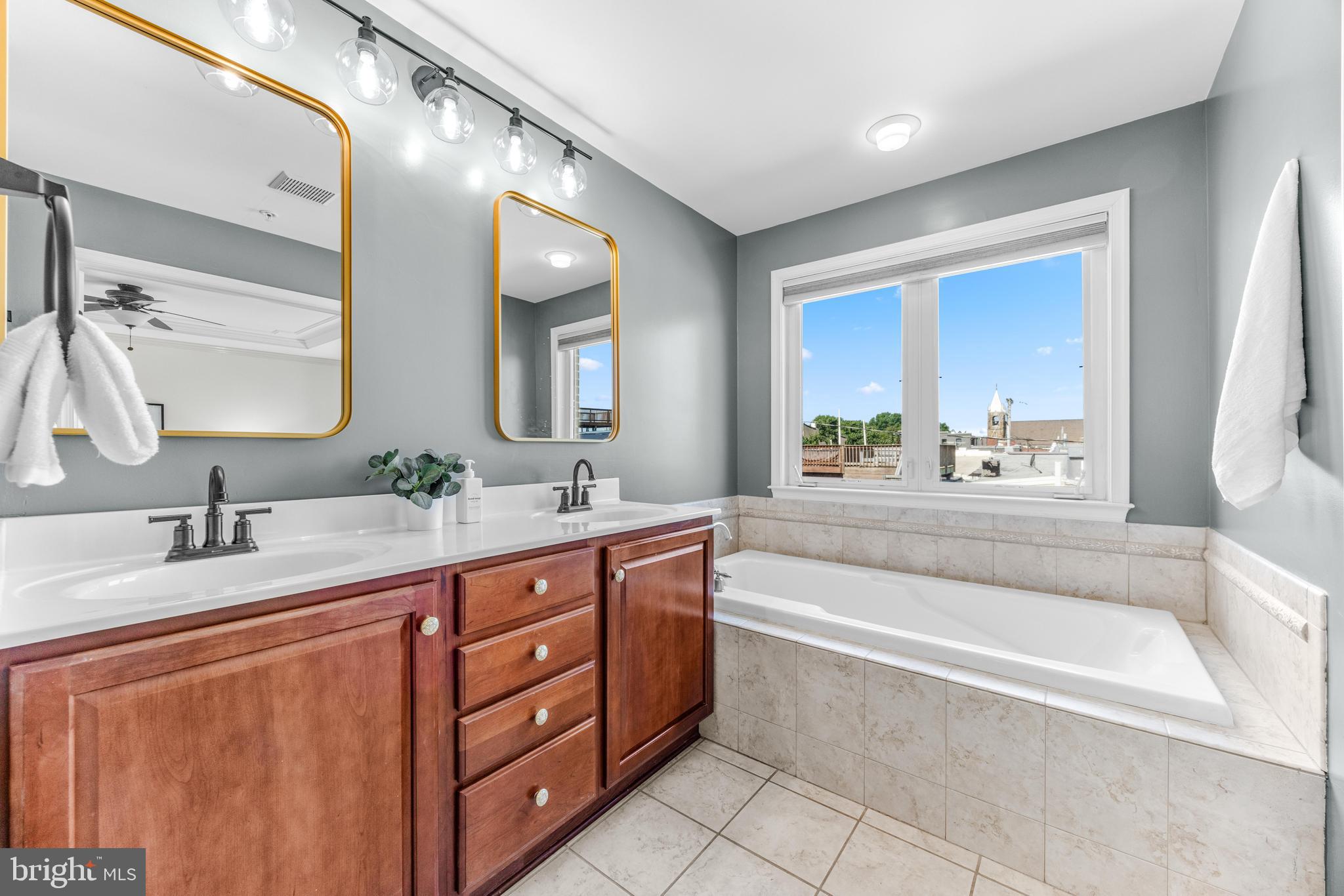 1436 Steuart Street Baltimore, MD 21230 - Photo 40 of 56 a spacious bathroom with a tub sink and mirror