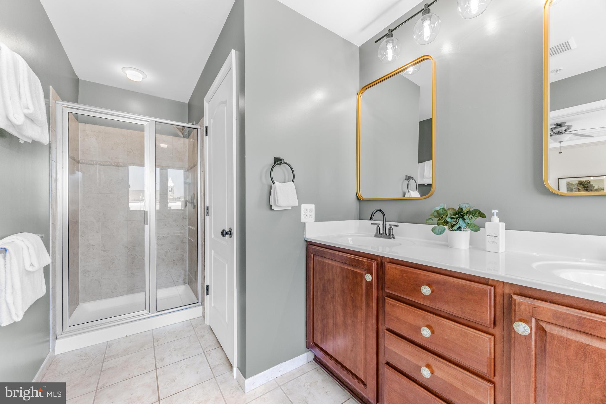 1436 Steuart Street Baltimore, MD 21230 - Photo 41 of 56 a spacious bathroom with a shower sink and mirror