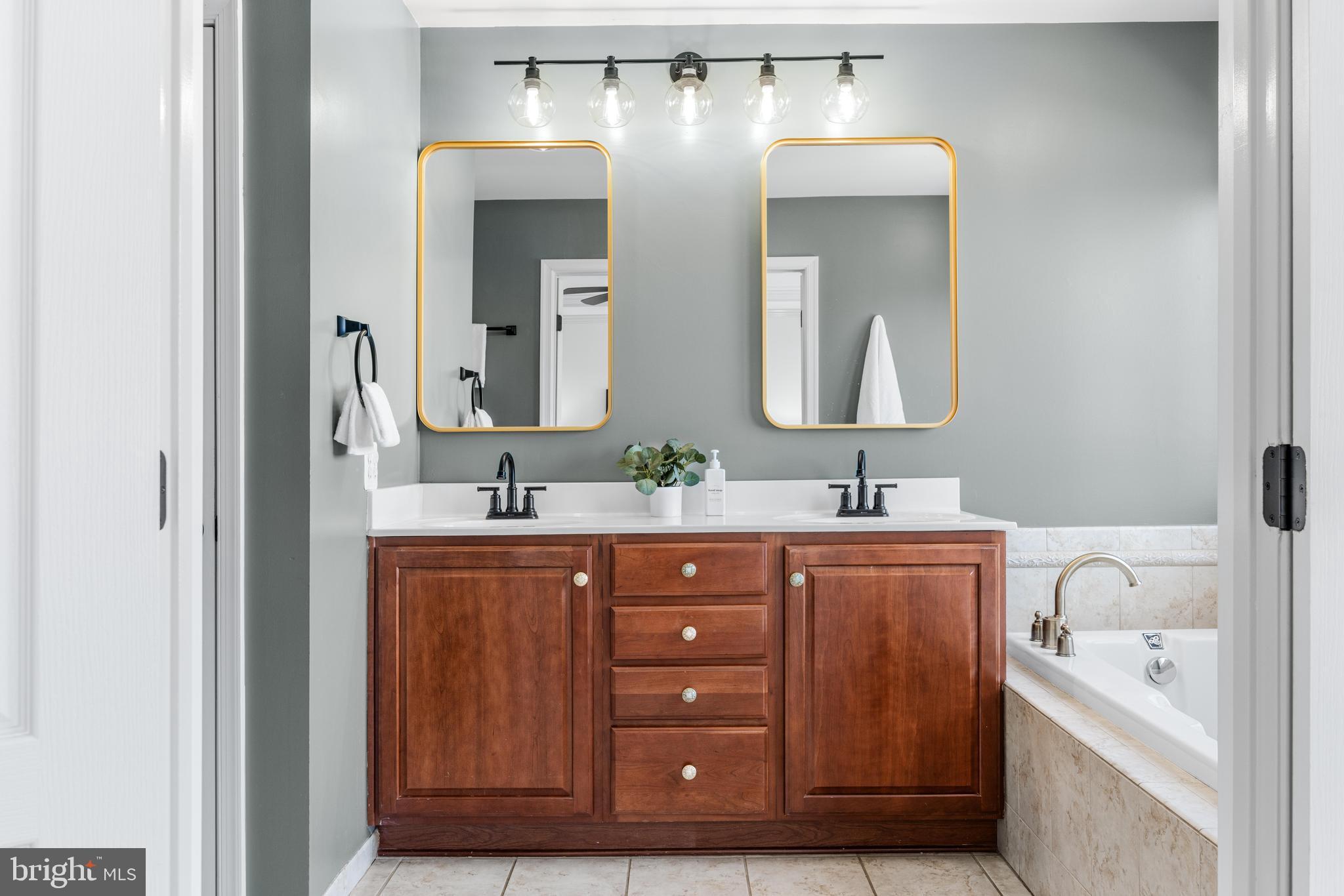 1436 Steuart Street Baltimore, MD 21230 - Photo 42 of 56 a spacious bathroom with a double vanity sink double and mirror