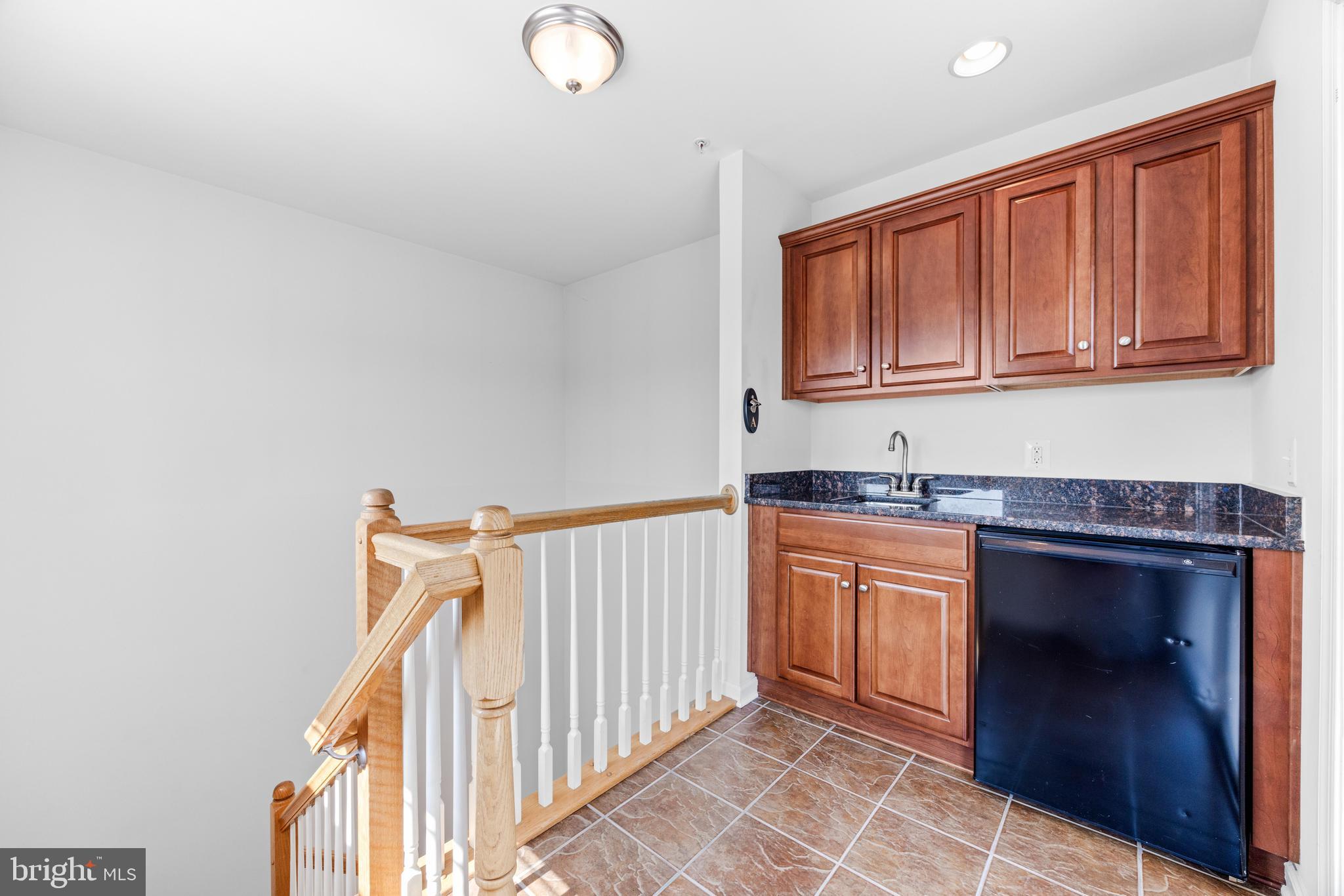 1436 Steuart Street Baltimore, MD 21230 - Photo 48 of 56 a kitchen with stainless steel appliances granite countertop a stove and a sink