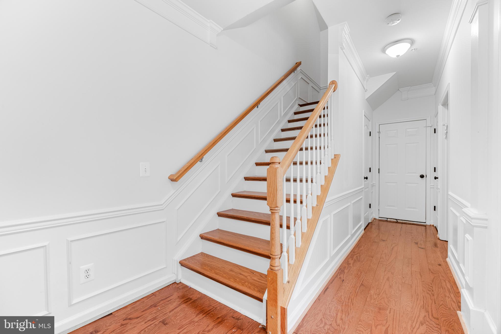 1436 Steuart Street Baltimore, MD 21230 - Photo 7 of 56 a view of entryway with stairs and wooden floor