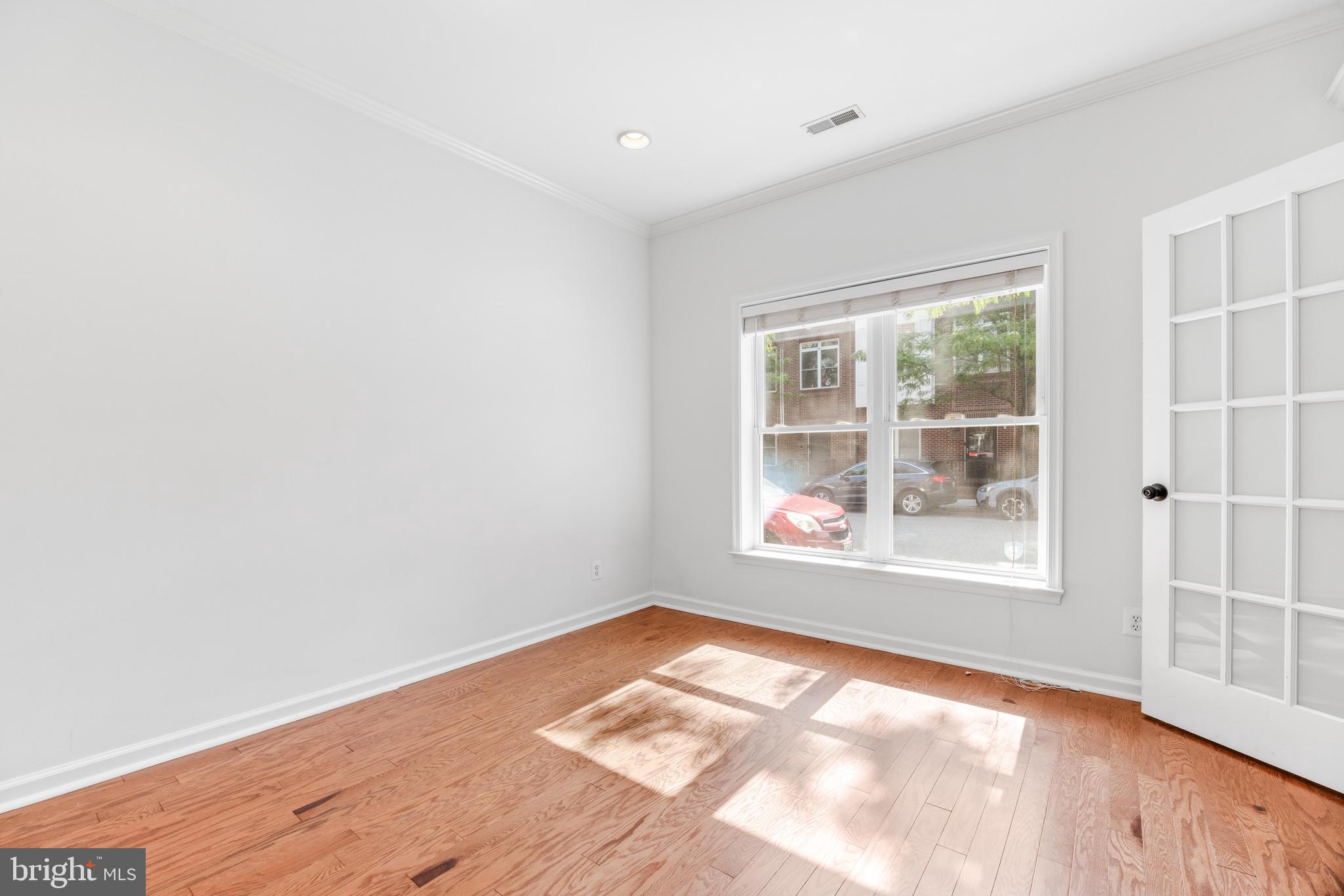 1436 Steuart Street Baltimore, MD 21230 - Photo 10 of 56 an empty room with wooden floor and windows